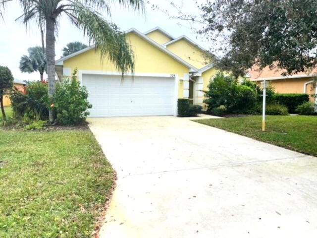 view of front of property featuring a garage and a front yard