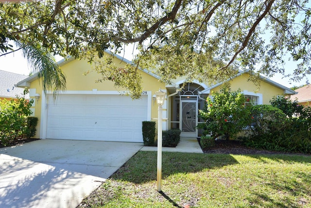 ranch-style home with a garage and a front lawn