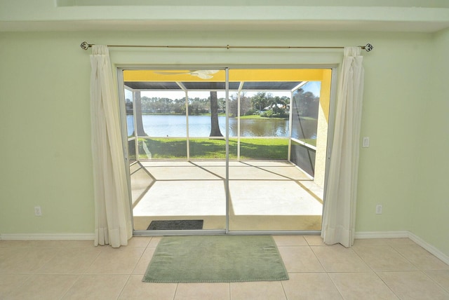 entryway featuring light tile patterned floors and a water view