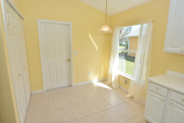 unfurnished dining area featuring light tile patterned flooring