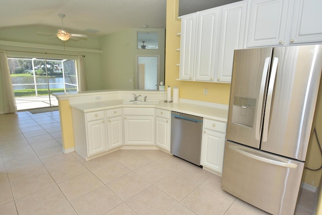 kitchen with sink, white cabinetry, light tile patterned floors, kitchen peninsula, and stainless steel appliances