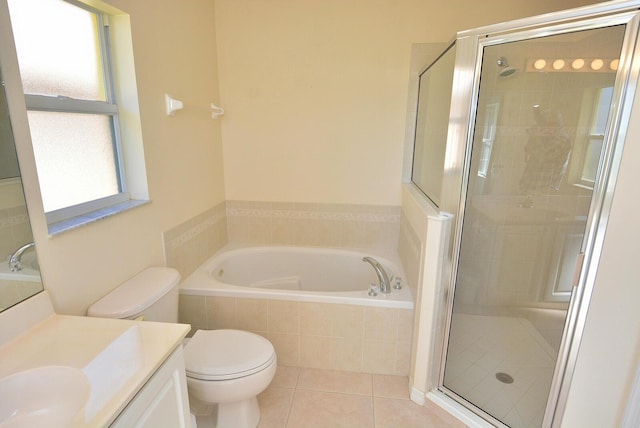 full bathroom with a wealth of natural light, tile patterned floors, and separate shower and tub