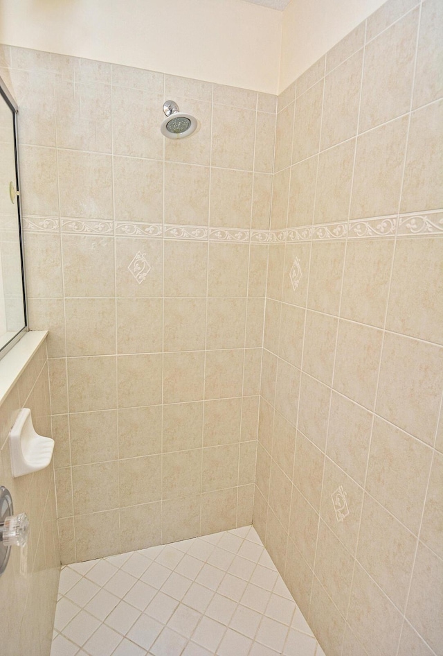 bathroom with a tile shower