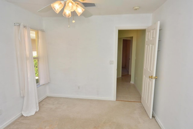 carpeted empty room featuring ceiling fan