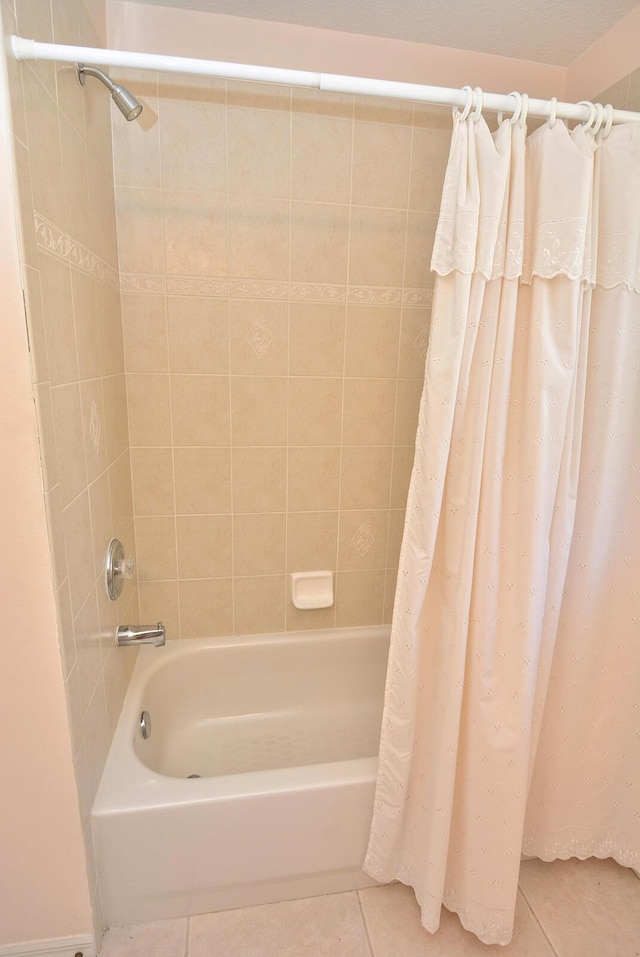 bathroom featuring shower / bathtub combination with curtain and tile patterned flooring