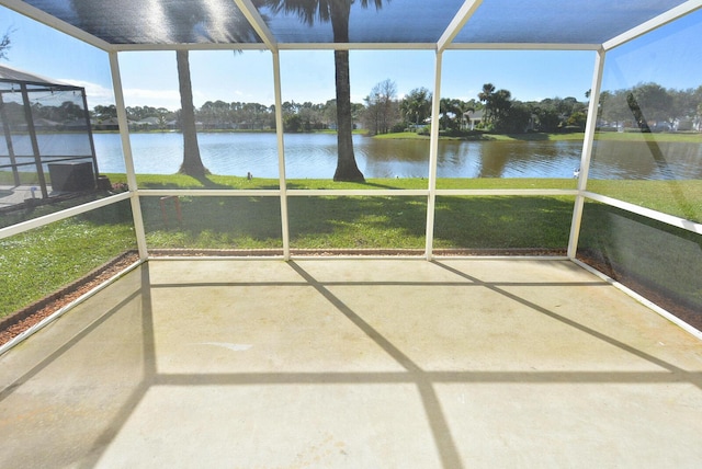 unfurnished sunroom featuring a water view