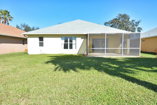 rear view of property with a lawn and a patio area