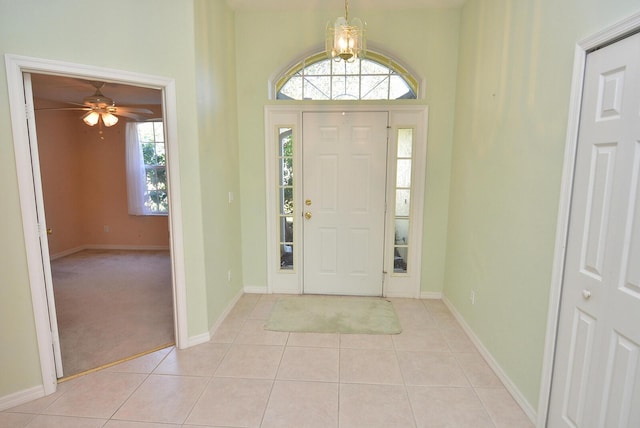 entryway with a wealth of natural light and light tile patterned flooring