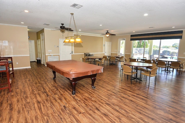 rec room with ornamental molding, dark hardwood / wood-style floors, and a textured ceiling