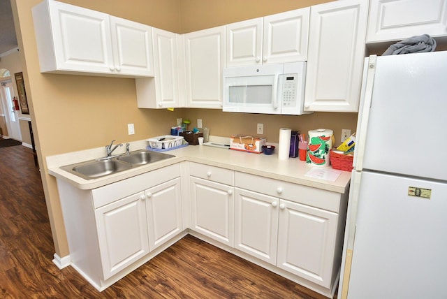 kitchen with white appliances, sink, and white cabinets