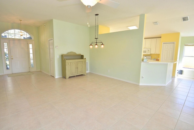 foyer entrance with light tile patterned floors, a textured ceiling, and ceiling fan