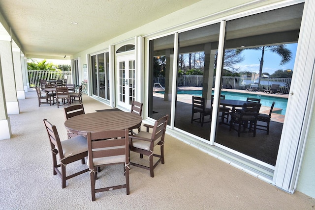 view of patio with a fenced in pool and french doors