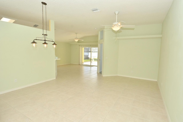 tiled spare room with ceiling fan