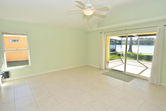 unfurnished room with a water view, ceiling fan, and light tile patterned flooring