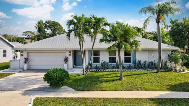 ranch-style house featuring a garage and a front lawn