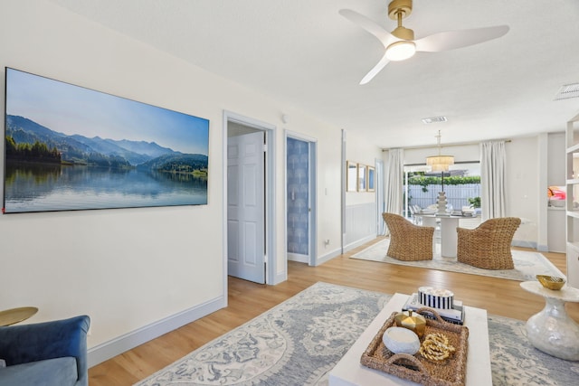 living room featuring light wood-type flooring and ceiling fan