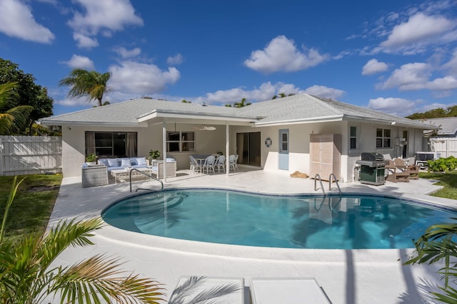 rear view of house featuring ceiling fan, a fenced in pool, an outdoor living space, and a patio