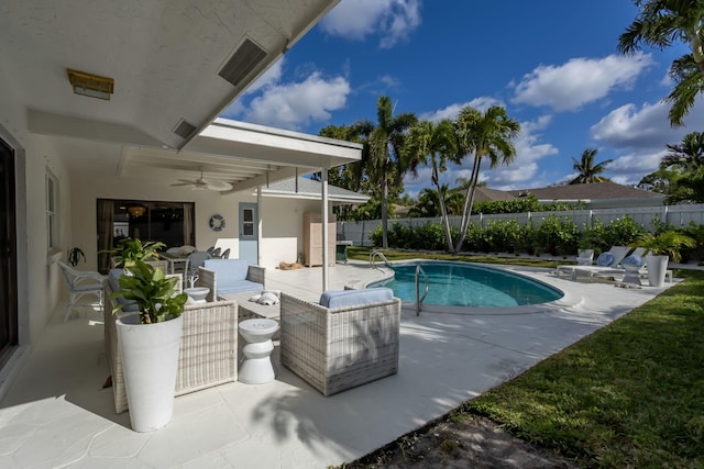 view of pool with an outdoor living space, a patio, and ceiling fan