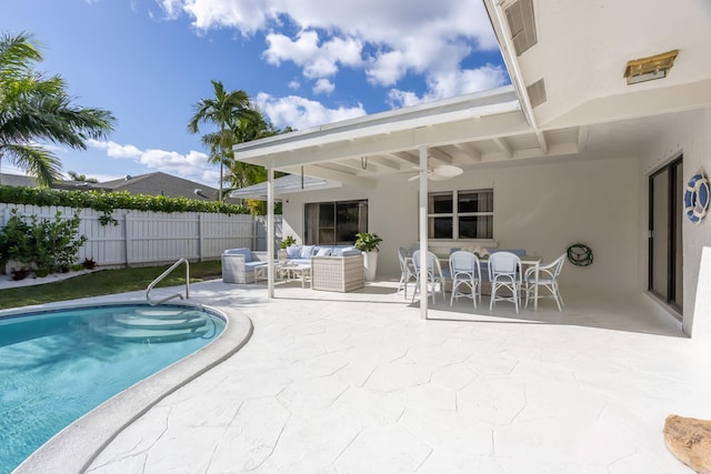 view of swimming pool featuring an outdoor living space, a patio area, and ceiling fan