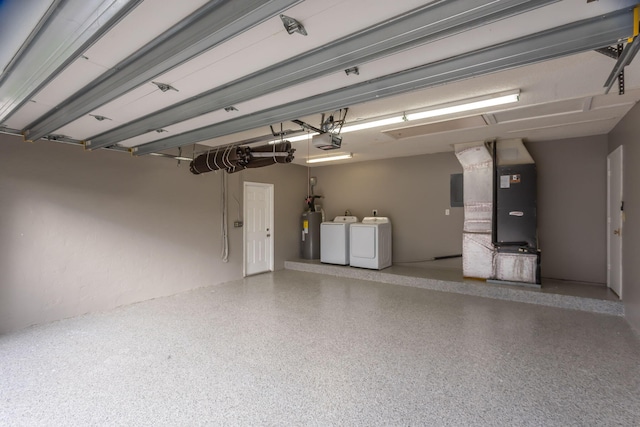 garage with a garage door opener, washing machine and dryer, and electric water heater