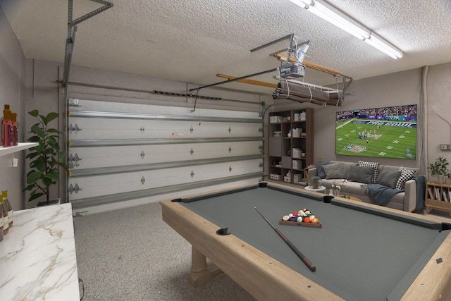 recreation room with pool table and a textured ceiling