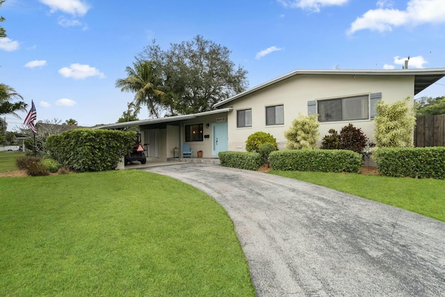 ranch-style home with a front lawn and a carport