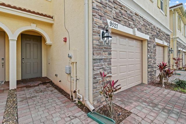 doorway to property featuring a garage