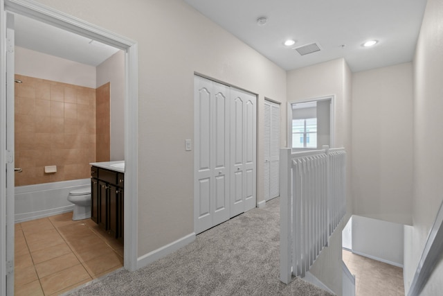 full bathroom featuring tiled shower / bath combo, vanity, tile patterned floors, and toilet