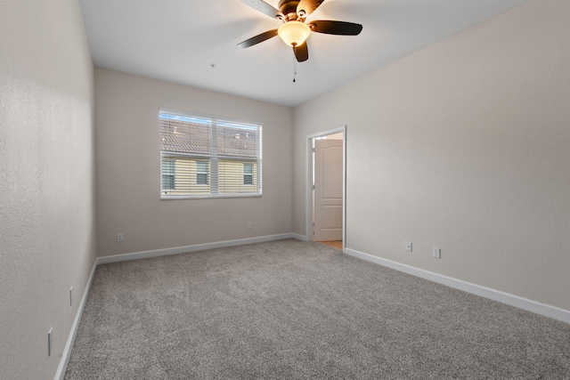 carpeted empty room featuring ceiling fan