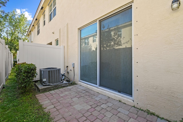 view of side of home featuring a patio and central air condition unit