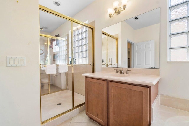 bathroom with vanity, plenty of natural light, and walk in shower