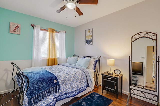 bedroom with dark hardwood / wood-style flooring and ceiling fan