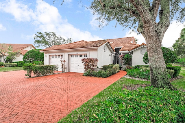 mediterranean / spanish home featuring a garage