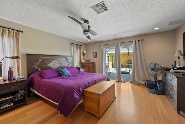 bedroom with ceiling fan, light wood-type flooring, a textured ceiling, and access to outside