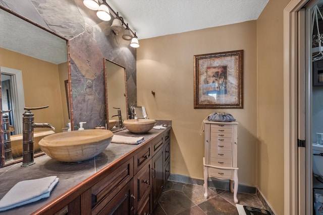 bathroom featuring vanity and a textured ceiling