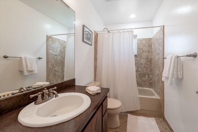 full bathroom with vanity, shower / bath combo with shower curtain, and toilet