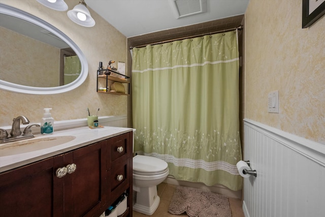 bathroom featuring a shower with curtain, vanity, toilet, and tile patterned flooring