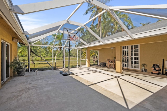 view of patio featuring glass enclosure