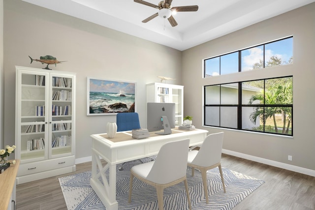 home office with ceiling fan and light wood-type flooring