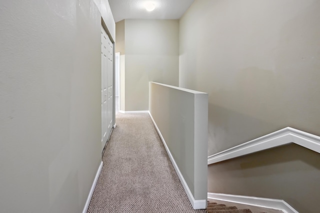 corridor featuring light colored carpet