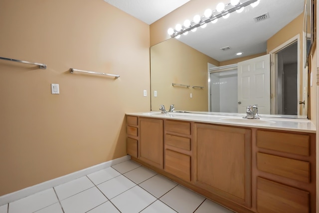 bathroom with walk in shower, tile patterned floors, and vanity