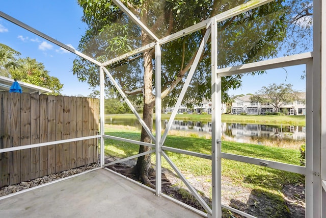 unfurnished sunroom with a water view