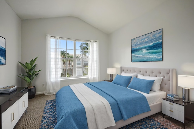 carpeted bedroom with lofted ceiling