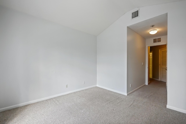 unfurnished room with light carpet and vaulted ceiling