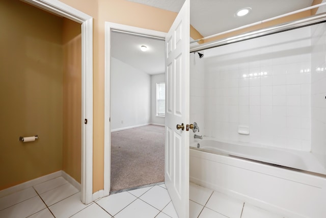 bathroom with tile patterned floors and washtub / shower combination