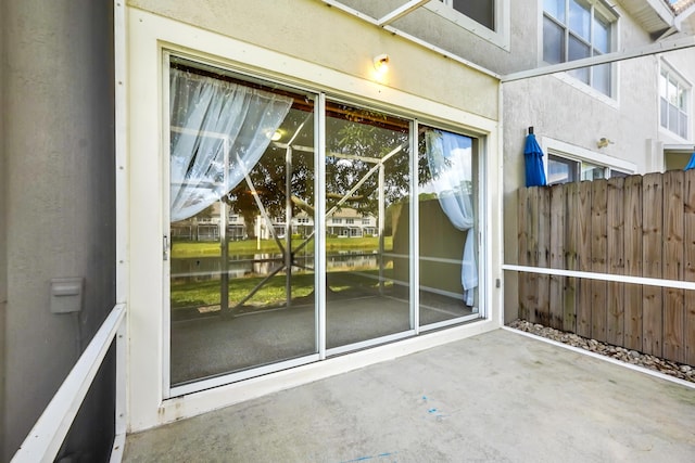 view of exterior entry featuring a patio area