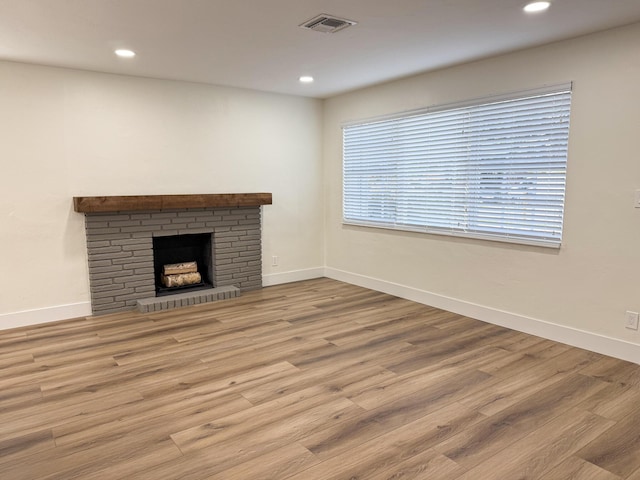 unfurnished living room with hardwood / wood-style floors and a fireplace