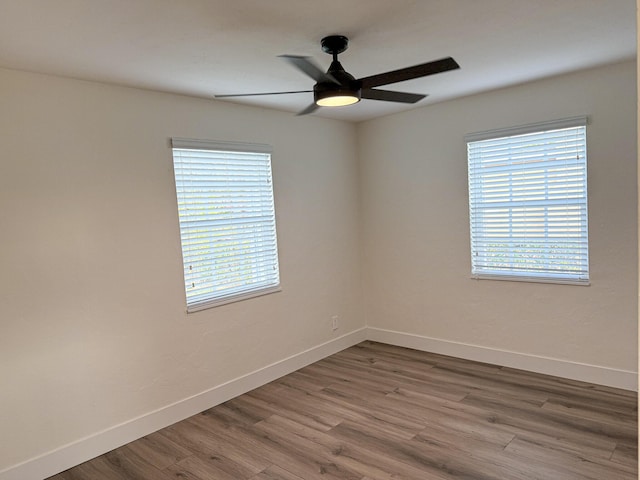 unfurnished room featuring hardwood / wood-style flooring, plenty of natural light, and ceiling fan