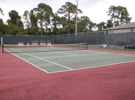 view of tennis court with fence