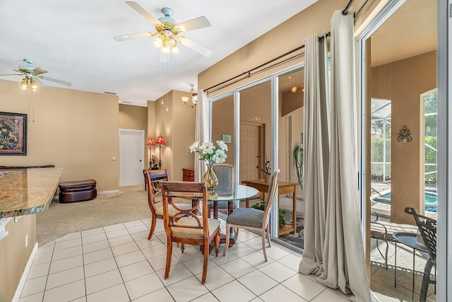 carpeted dining space with ceiling fan